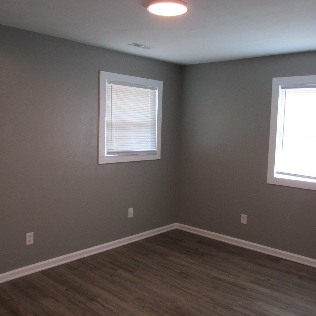 1525 Andrews Road Northwest Roanoke, VA 24017 - Photo 12 of 14 an empty room with wooden floor and windows
