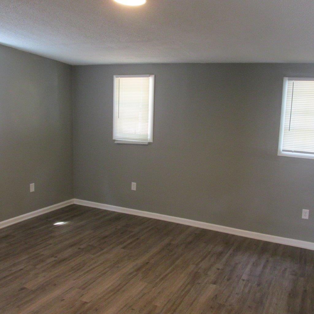 1525 Andrews Road Northwest Roanoke, VA 24017 - Photo 6 of 14 an empty room with wooden floor and windows