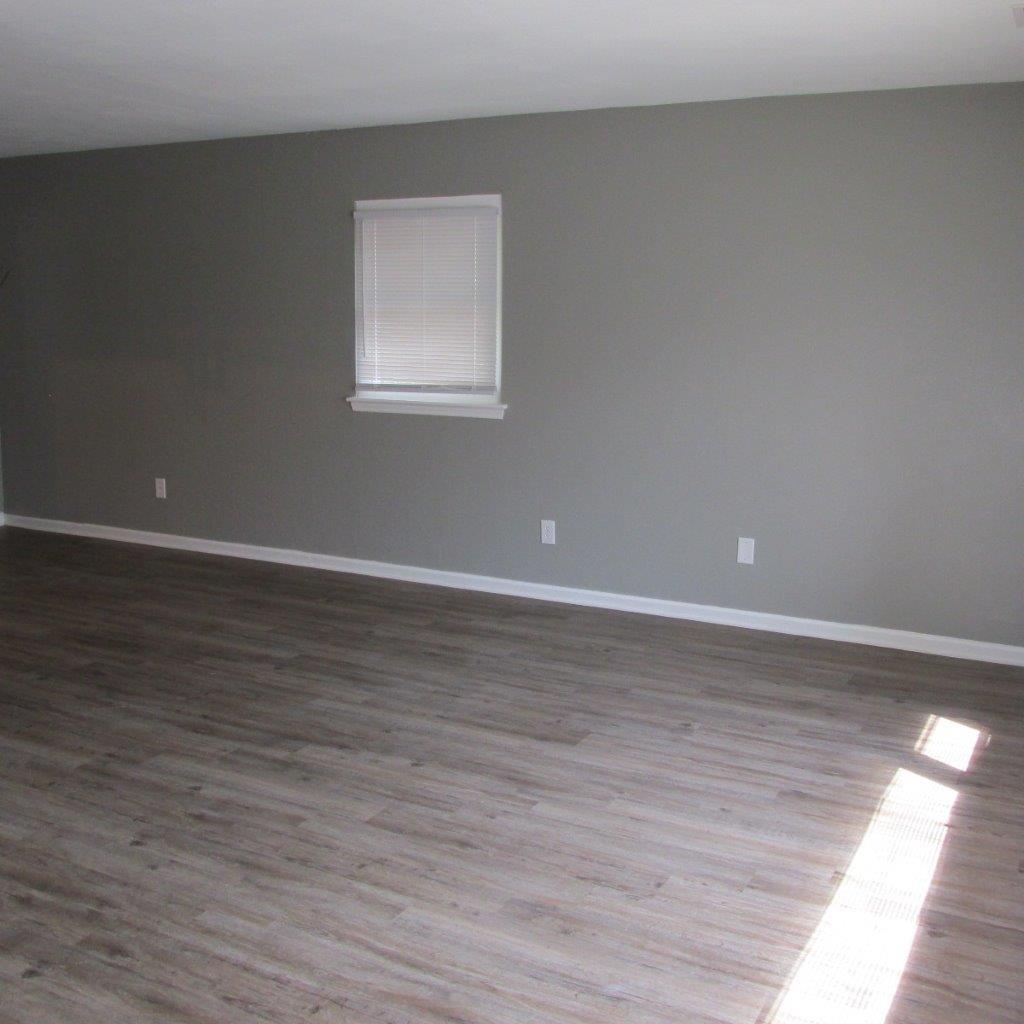 1525 Andrews Road Northwest Roanoke, VA 24017 - Photo 7 of 14 a view of an empty room with wooden floor and a window