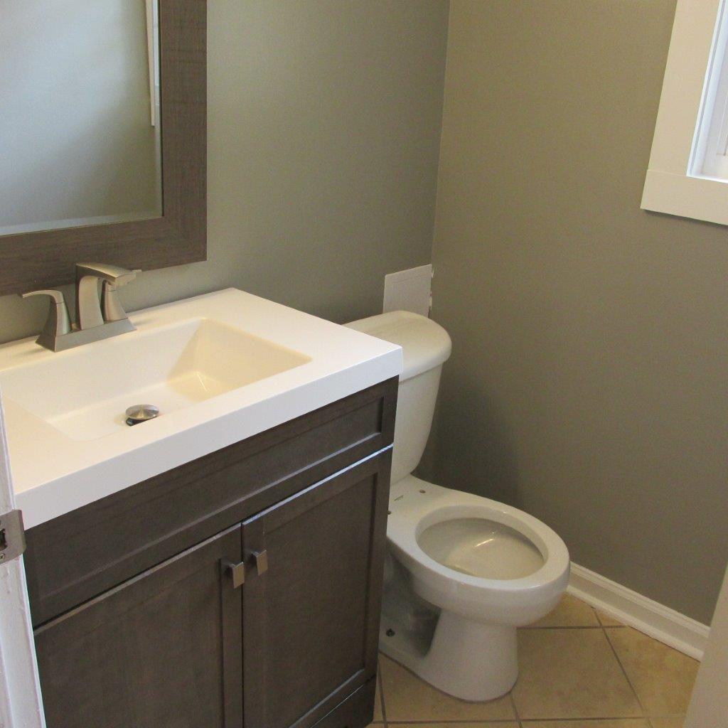 1525 Andrews Road Northwest Roanoke, VA 24017 - Photo 9 of 14 a bathroom with a sink a toilet and a mirror