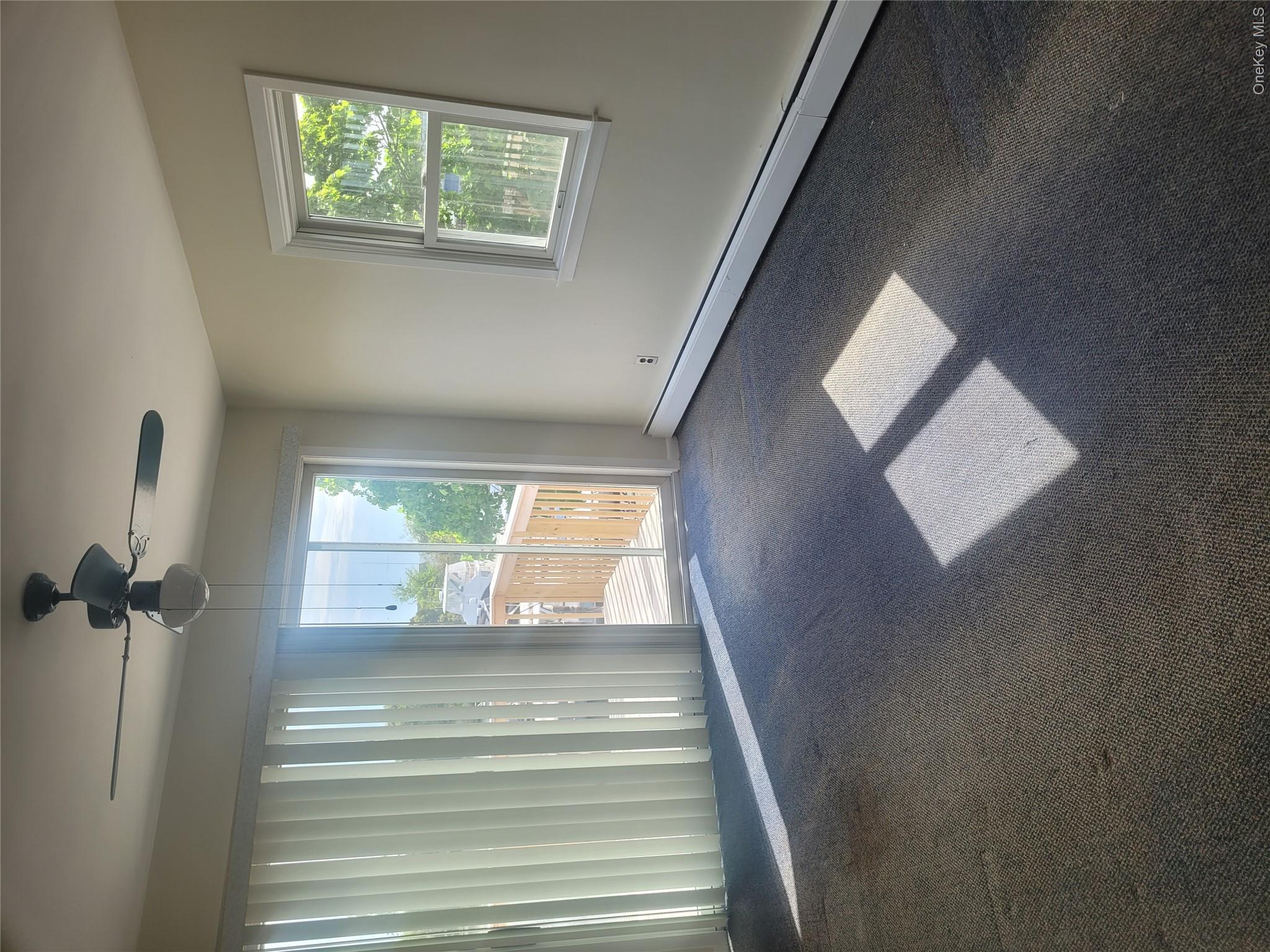 8 Cornell Road East Patchogue, NY 11772 - Photo 11 of 18 an empty room with windows