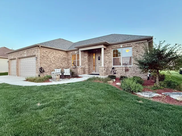 a view of a house with backyard and sitting area
