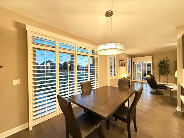 a dining room with furniture and wooden floor