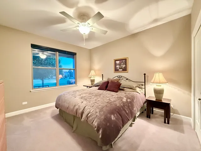 a spacious bedroom with a bed and a window