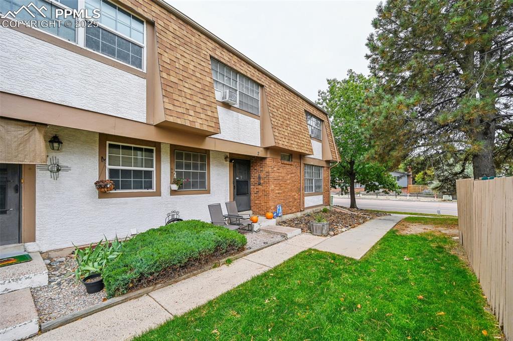 1131 Willow Bend Circle, Unit 2 Colorado Springs, CO 80918 - Photo 1 of 21 a front view of a house with garden