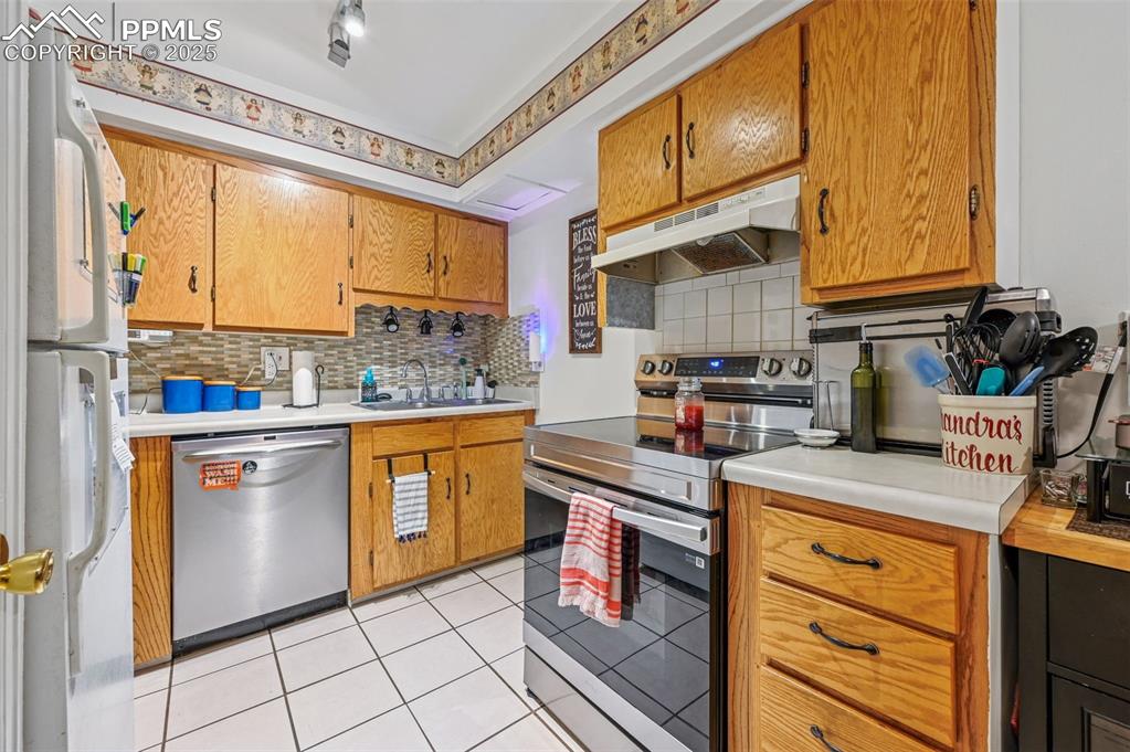 1131 Willow Bend Circle, Unit 2 Colorado Springs, CO 80918 - Photo 11 of 21 a kitchen with stainless steel appliances granite countertop a stove a sink and a refrigerator