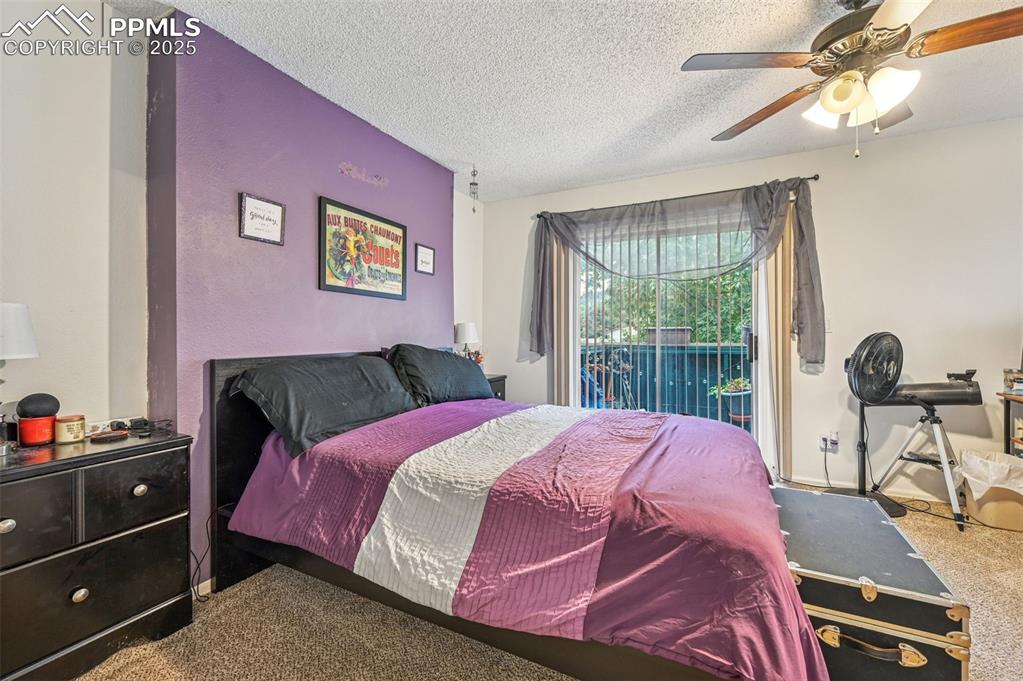 1131 Willow Bend Circle, Unit 2 Colorado Springs, CO 80918 - Photo 18 of 21 a bed room with a bed and a tv