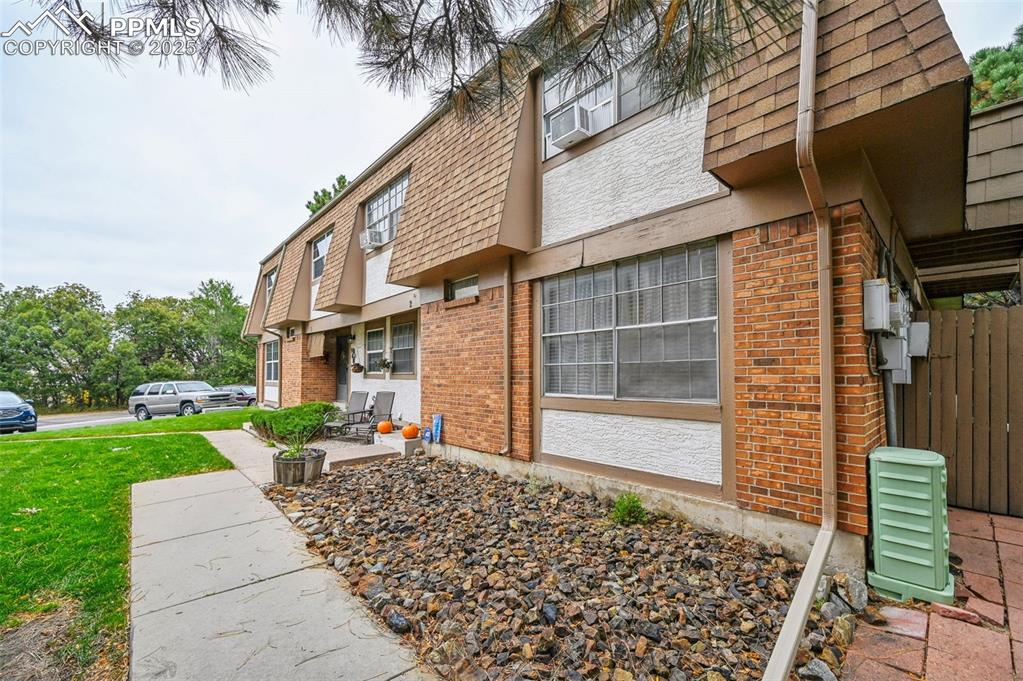 1131 Willow Bend Circle, Unit 2 Colorado Springs, CO 80918 - Photo 3 of 21 a backyard of a house with barbeque oven table and chairs