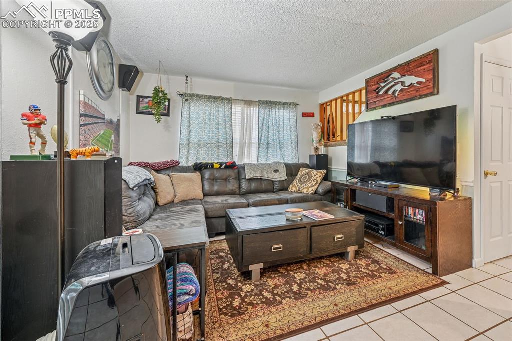 1131 Willow Bend Circle, Unit 2 Colorado Springs, CO 80918 - Photo 6 of 21 a living room with furniture and a flat screen tv