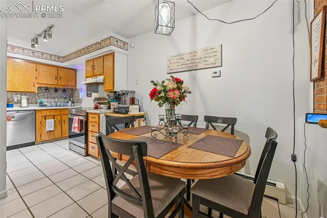 a view of a dining room with furniture and a chandelier