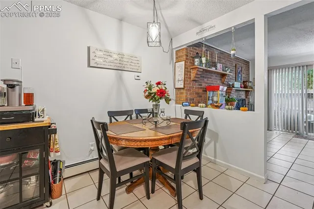 a view of a dining room with furniture and chandelier