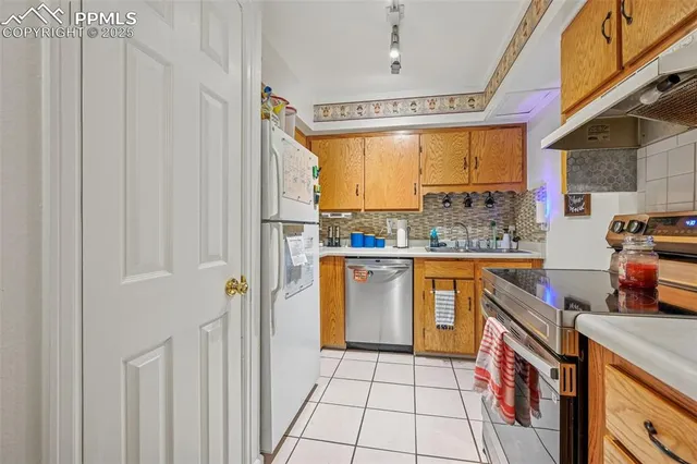 a kitchen with a sink a counter top space and cabinets