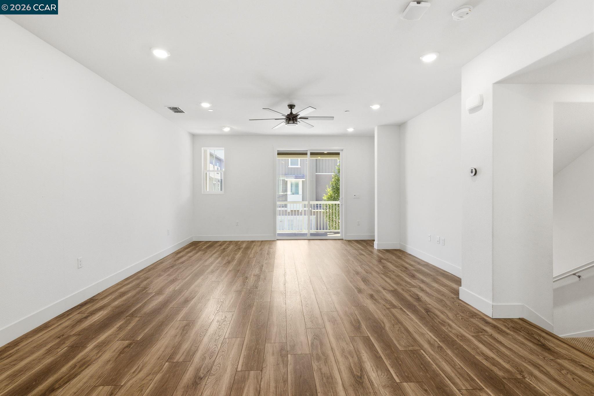 205 Plum Tree Street Livermore, CA 94551 - Photo 16 of 47 an empty room with wooden floor and windows