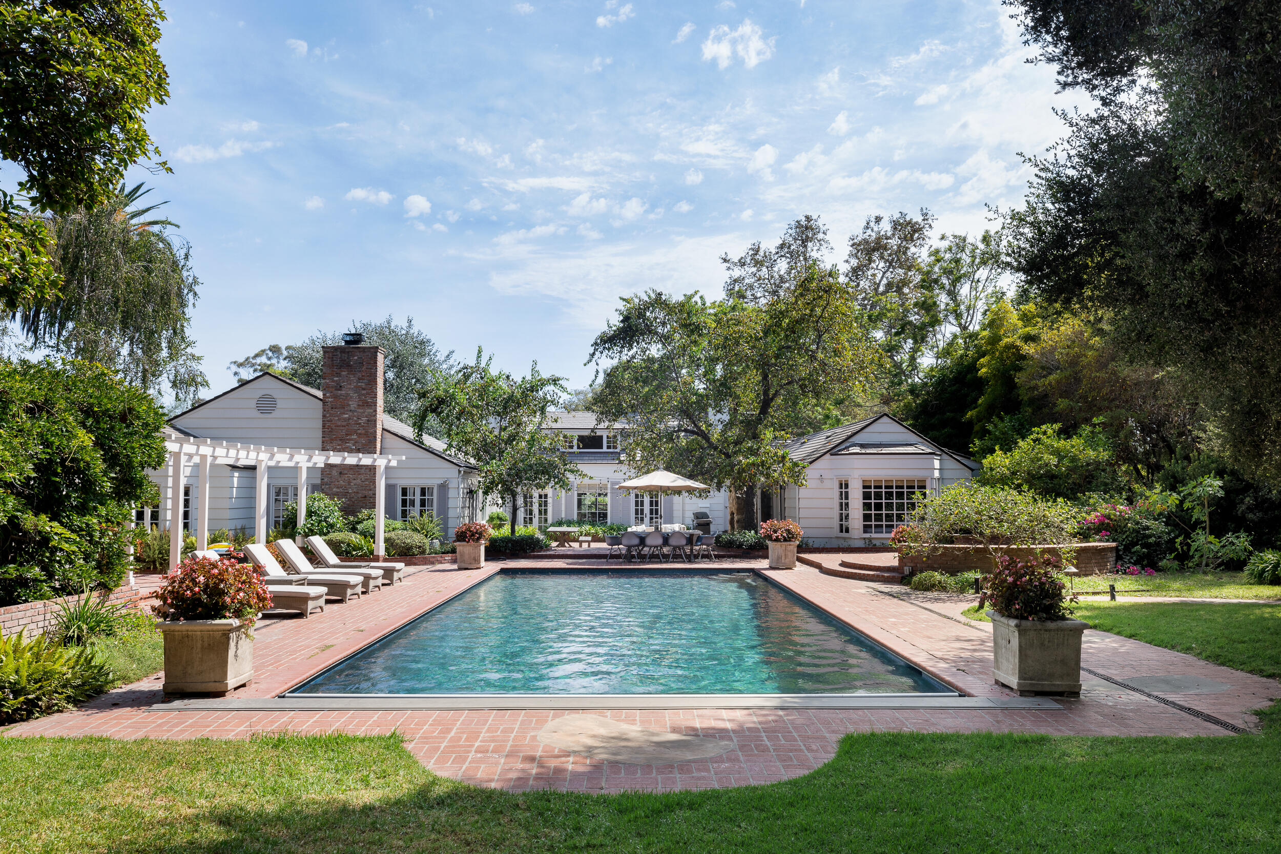 a aerial view of a house with swimming pool garden and outdoor seating