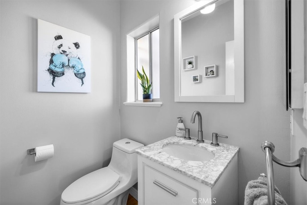 314 Penn Street, Unit 2 El Segundo, CA 90245 - Photo 11 of 23 a bathroom with a granite countertop toilet sink and mirror