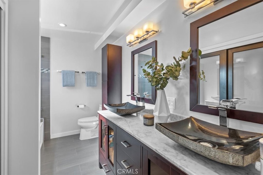 314 Penn Street, Unit 2 El Segundo, CA 90245 - Photo 14 of 23 a bathroom with a granite countertop sink and a mirror