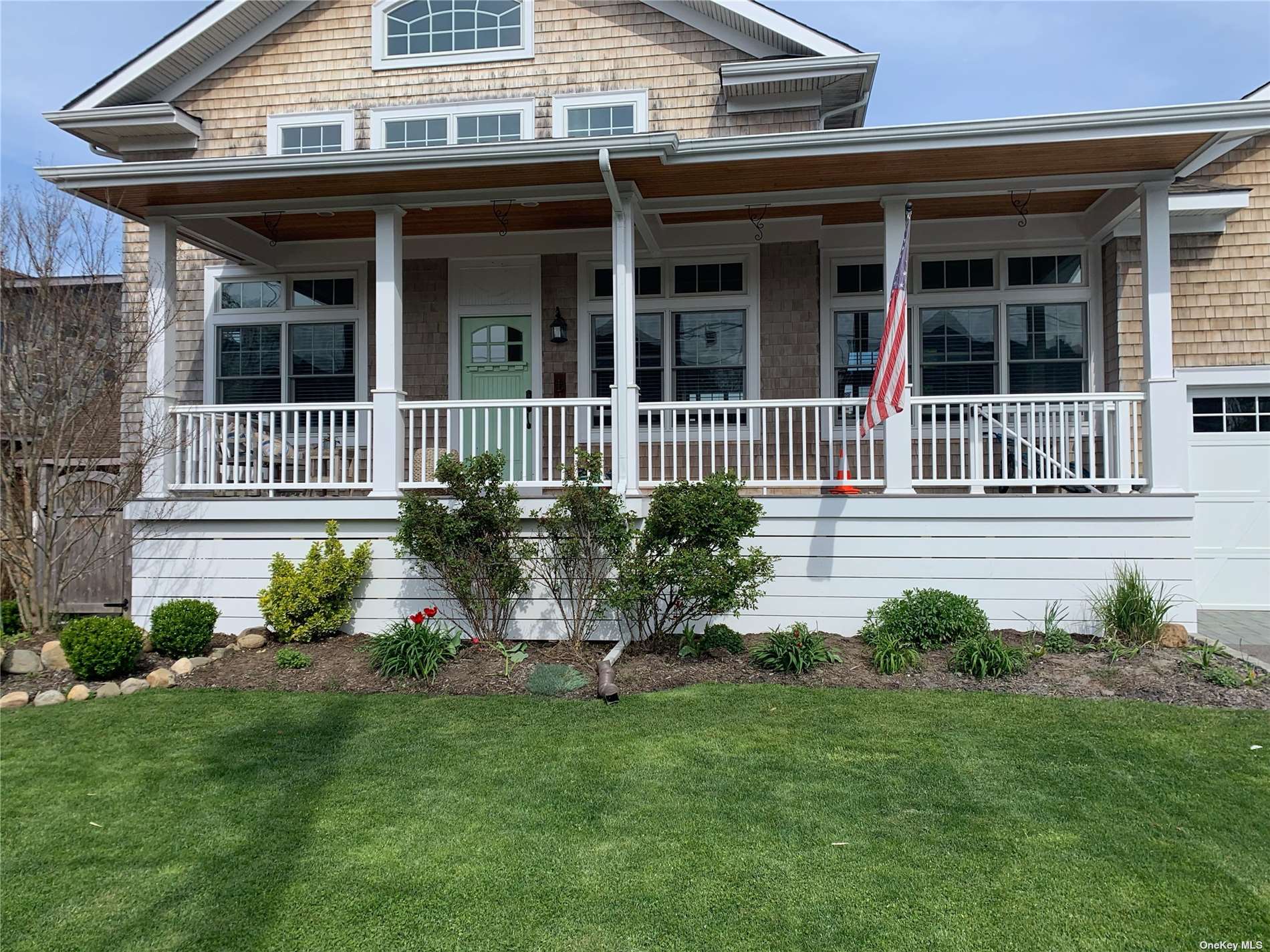10 Inlet View Bay Shore, NY 11706 - Photo 1 of 1 a front view of a house with a garden