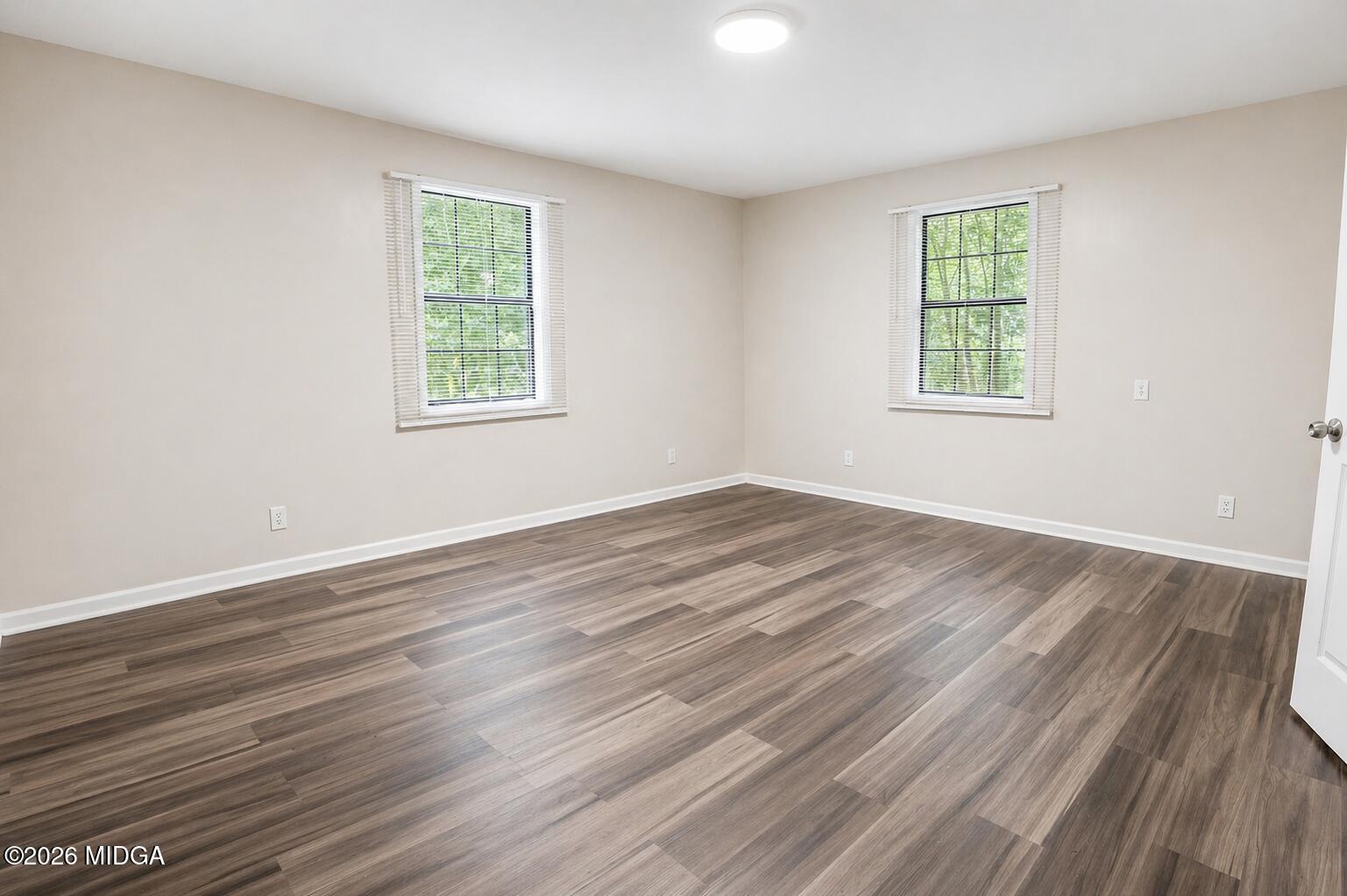 1957 Kitchens Road Macon, GA 31211 - Photo 15 of 18 an empty room with wooden floor and windows
