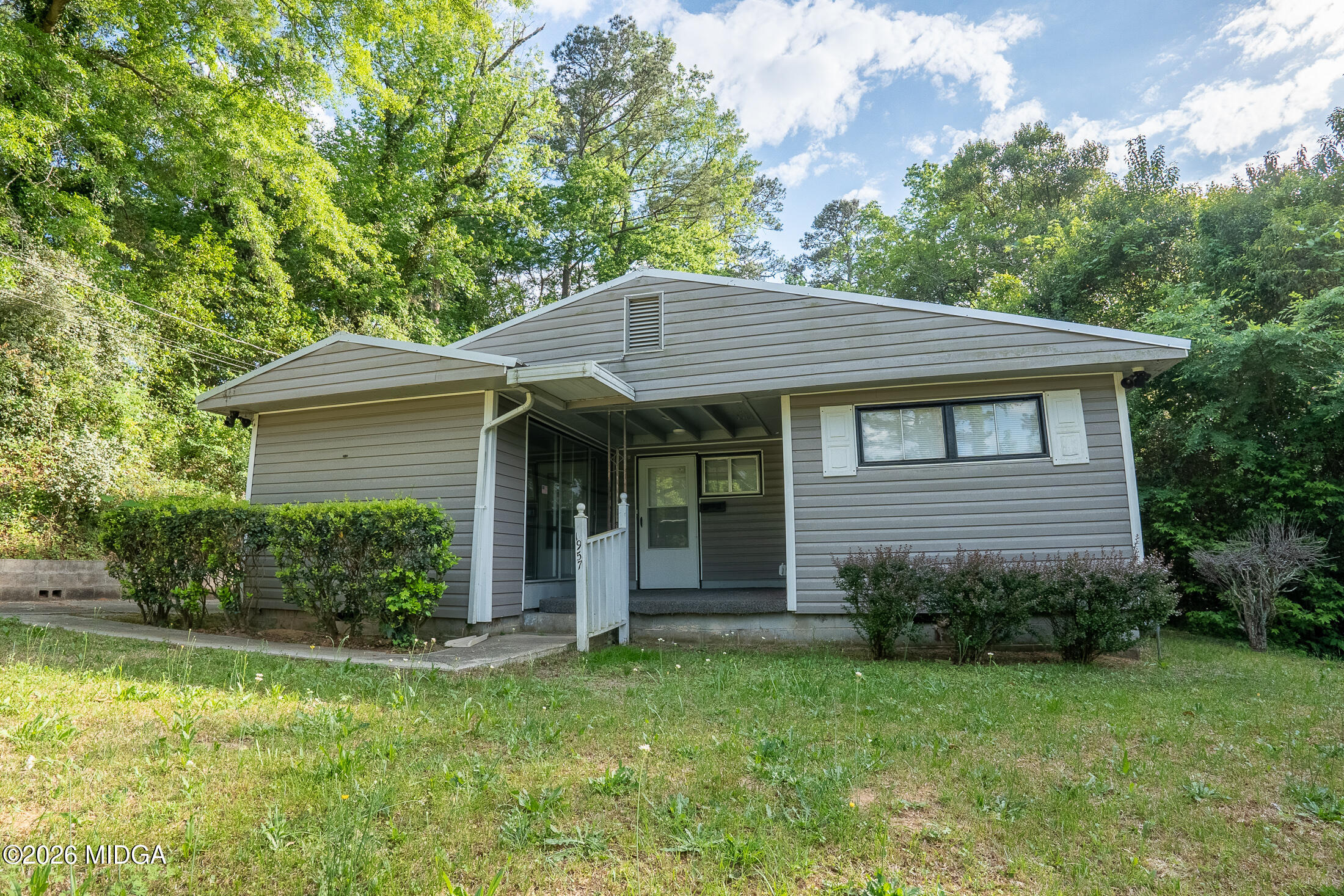 1957 Kitchens Road Macon, GA 31211 - Photo 2 of 18 a view of a house with a yard plants and large tree
