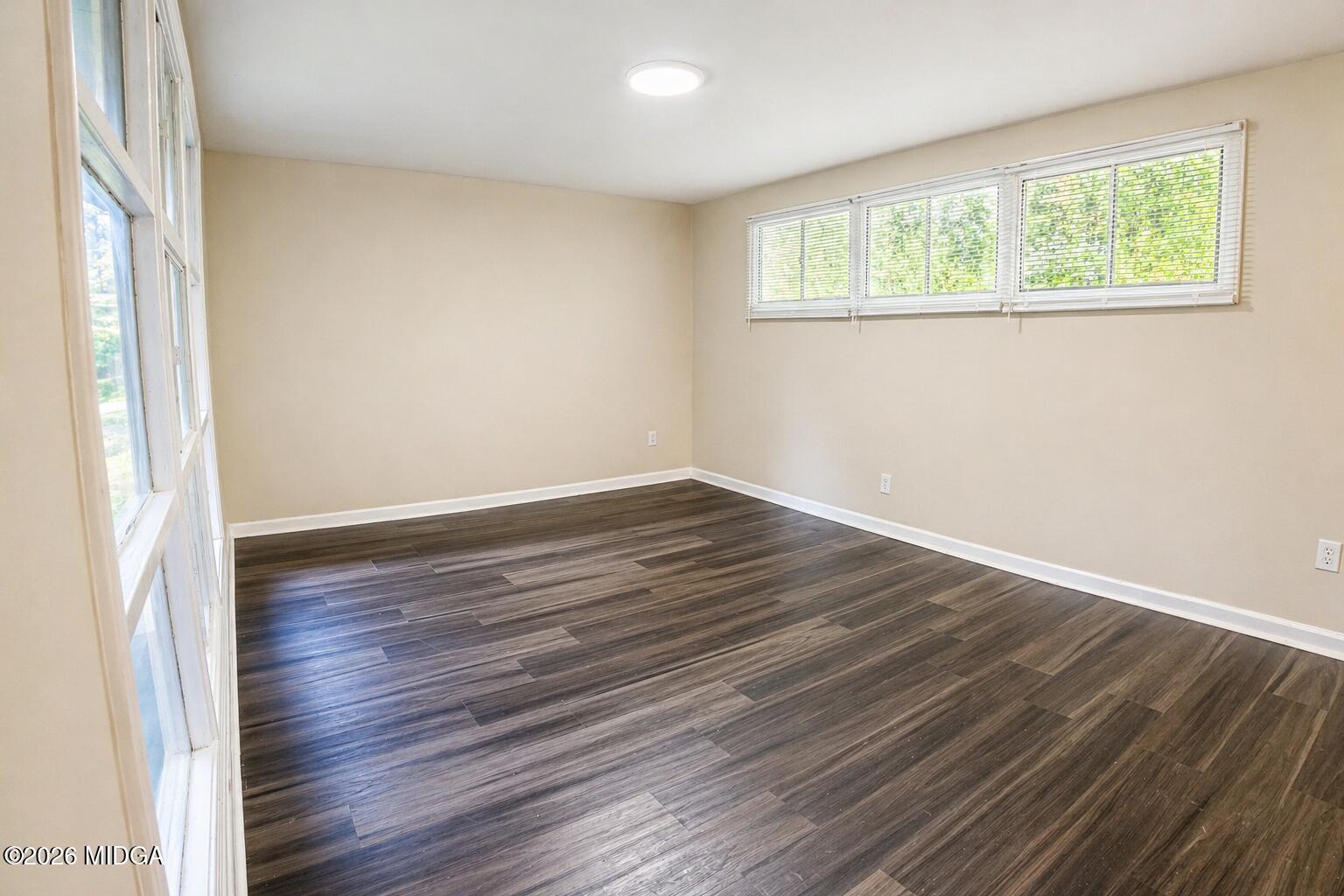 1957 Kitchens Road Macon, GA 31211 - Photo 4 of 18 an empty room with wooden floor and windows