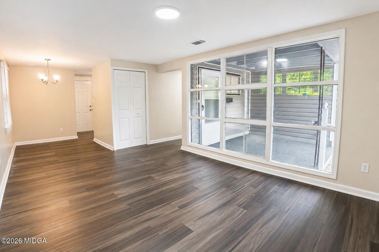 1957 Kitchens Road Macon, GA 31211 - Photo 5 of 18 an empty room with wooden floor and windows