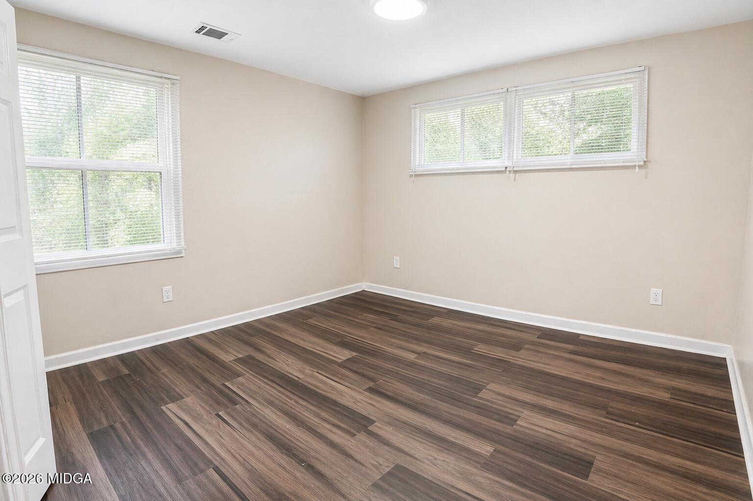 1957 Kitchens Road Macon, GA 31211 - Photo 9 of 18 a view of an empty room with wooden floor and a window
