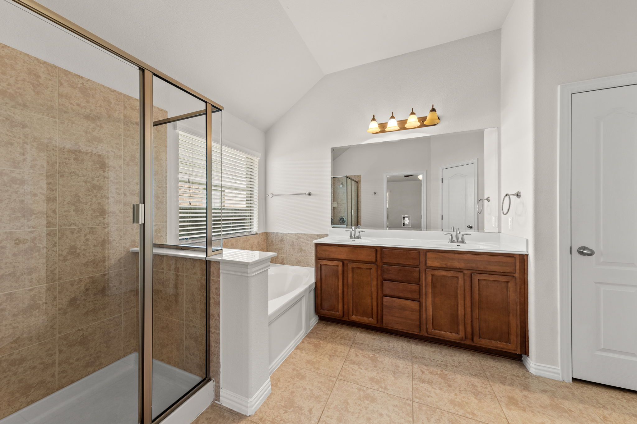 411 Tascate Street Georgetown, TX 78628 - Photo 38 of 41 Indulge in a primary bathroom featuring a spacious shower and a vanity with dual sinks.