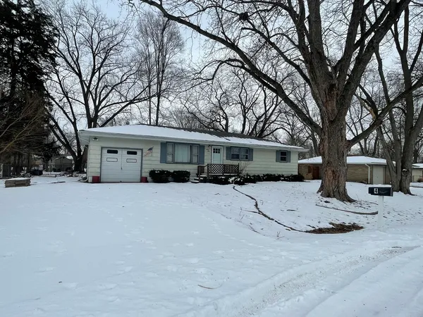 a view of a house with snow on the road