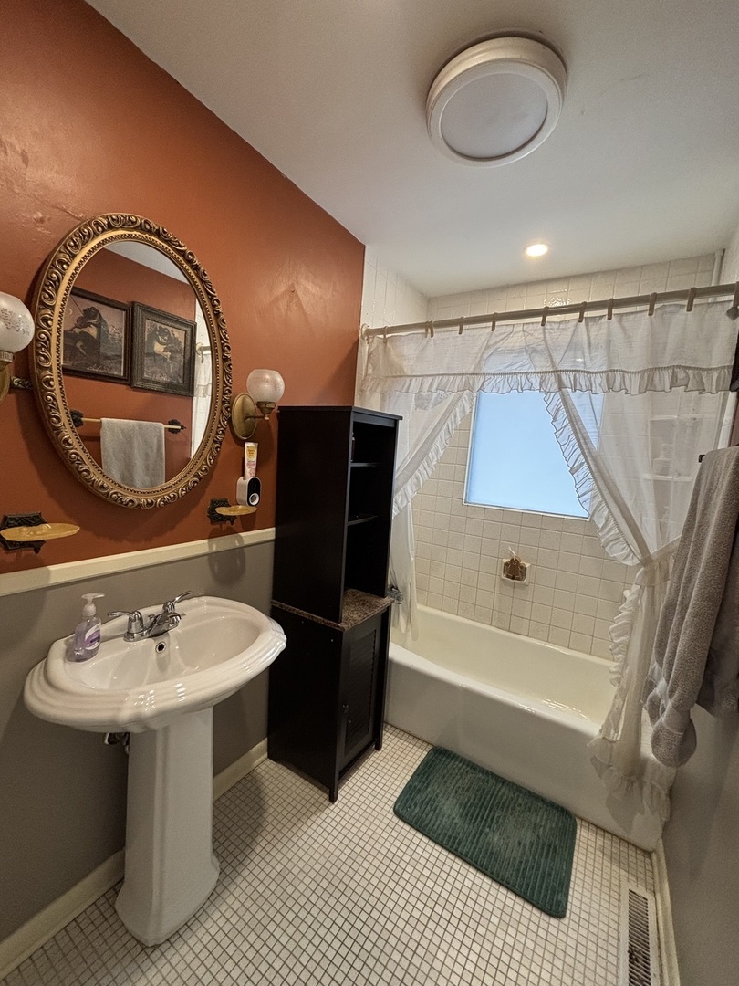 44 Norman Street Kankakee, IL 60901 - Photo 6 of 14 a bathroom with a sink a toilet and a mirror