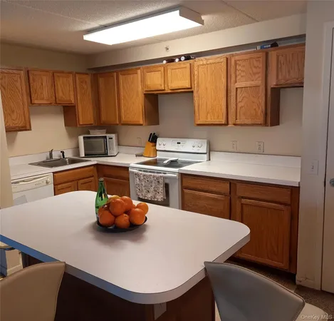 a kitchen with a sink cabinets and appliances