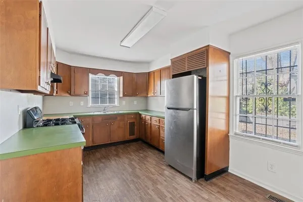 a kitchen with a refrigerator sink and cabinets