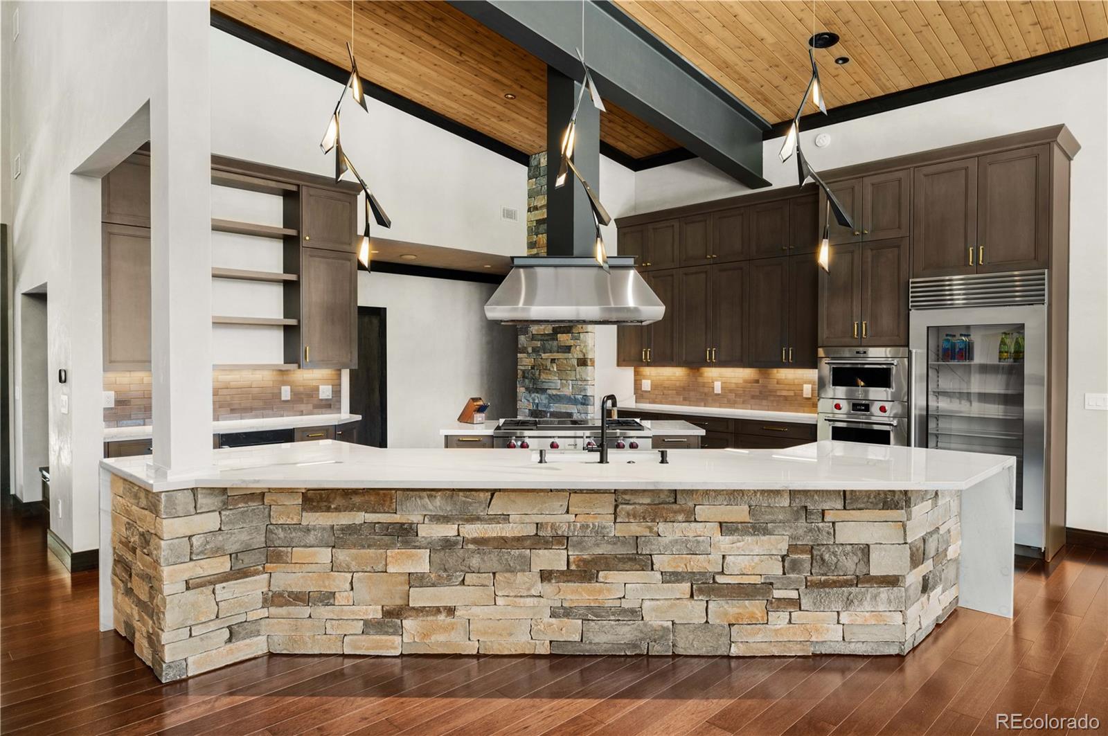 21261 Broadview Road Nathrop, CO 81236 - Photo 12 of 49 a kitchen with stainless steel appliances granite countertop a stove and a wooden cabinets