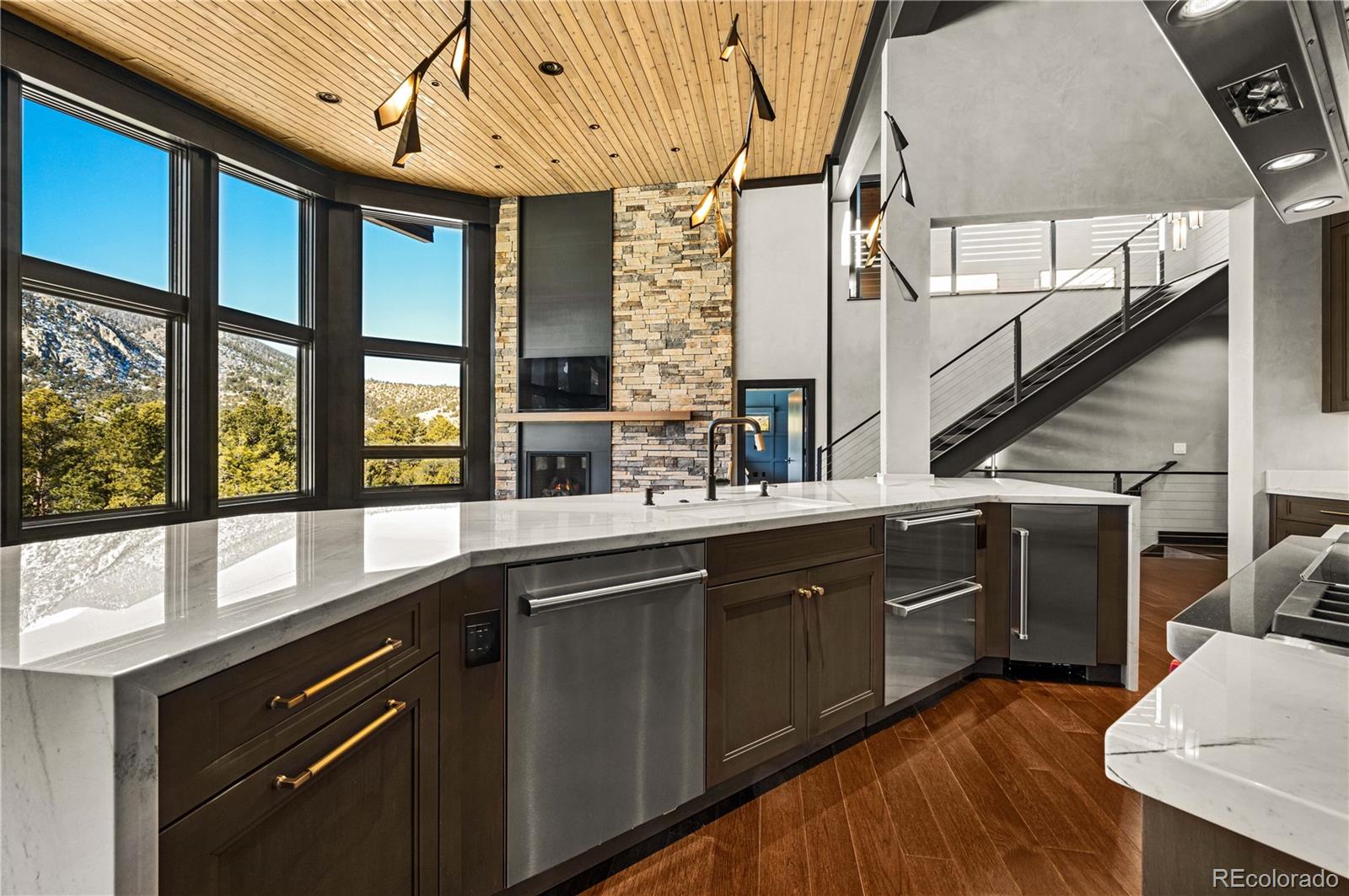 21261 Broadview Road Nathrop, CO 81236 - Photo 13 of 49 a kitchen with stainless steel appliances granite countertop a sink and wooden cabinets