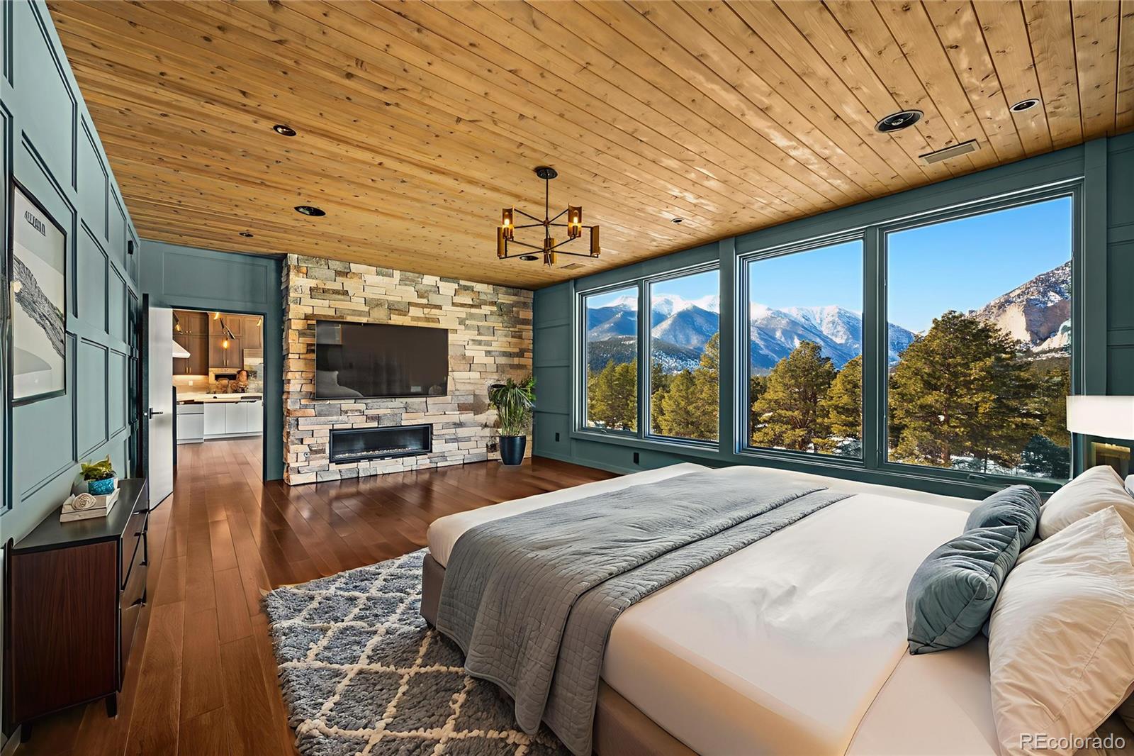 21261 Broadview Road Nathrop, CO 81236 - Photo 21 of 49 a spacious bedroom with a large bed and a flat screen tv