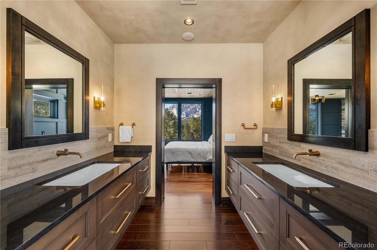 21261 Broadview Road Nathrop, CO 81236 - Photo 23 of 49 a spacious bathroom with a double vanity sink and a mirror