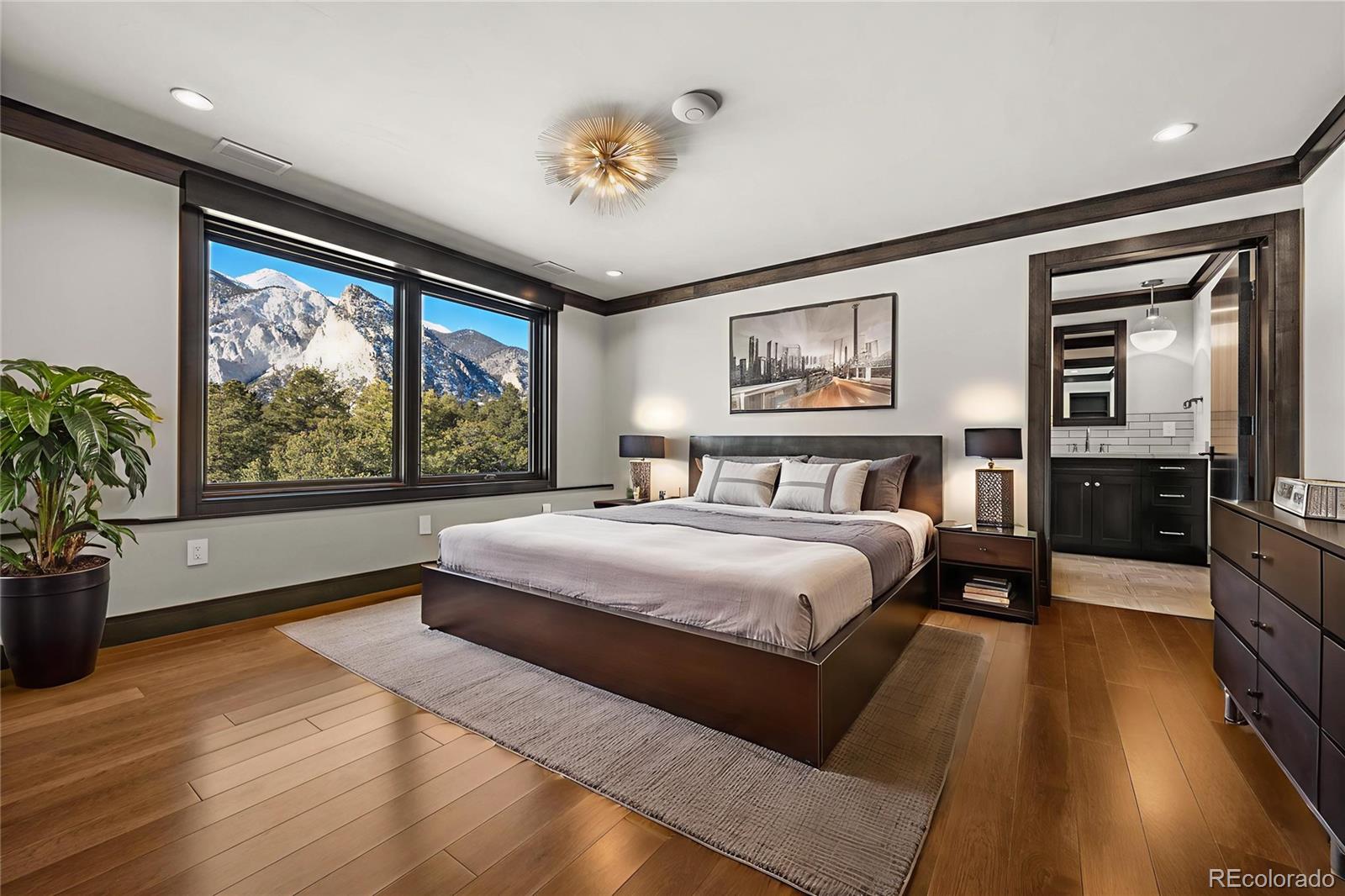 21261 Broadview Road Nathrop, CO 81236 - Photo 37 of 49 a bedroom with a large bed and a large window