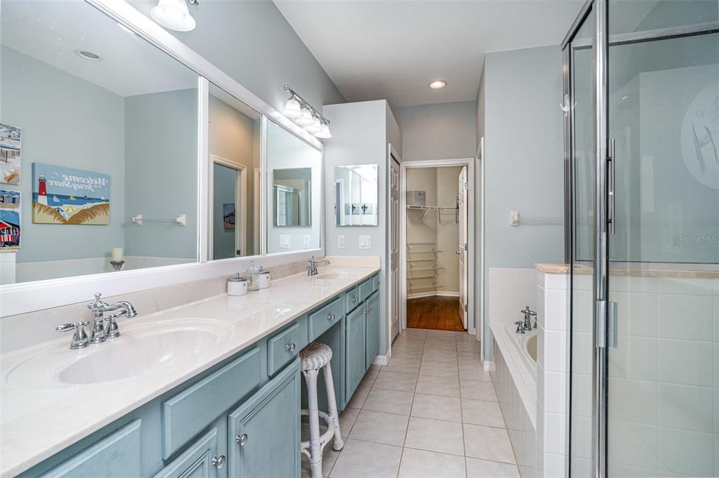 302 Latitude Place Apollo Beach, FL 33572 - Photo 17 of 50 a bathroom with a double vanity sink and mirror with shower