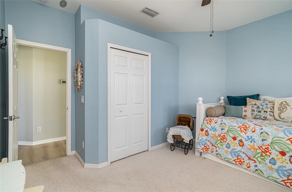 302 Latitude Place Apollo Beach, FL 33572 - Photo 21 of 50 a bedroom with a bed and a chandelier