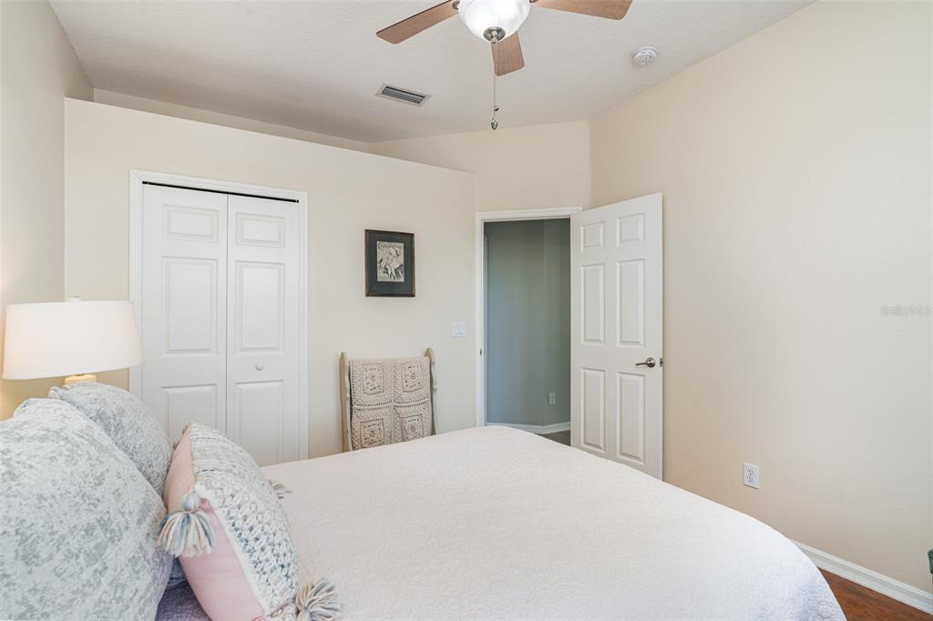 302 Latitude Place Apollo Beach, FL 33572 - Photo 23 of 50 a bedroom with a bed and a chandelier