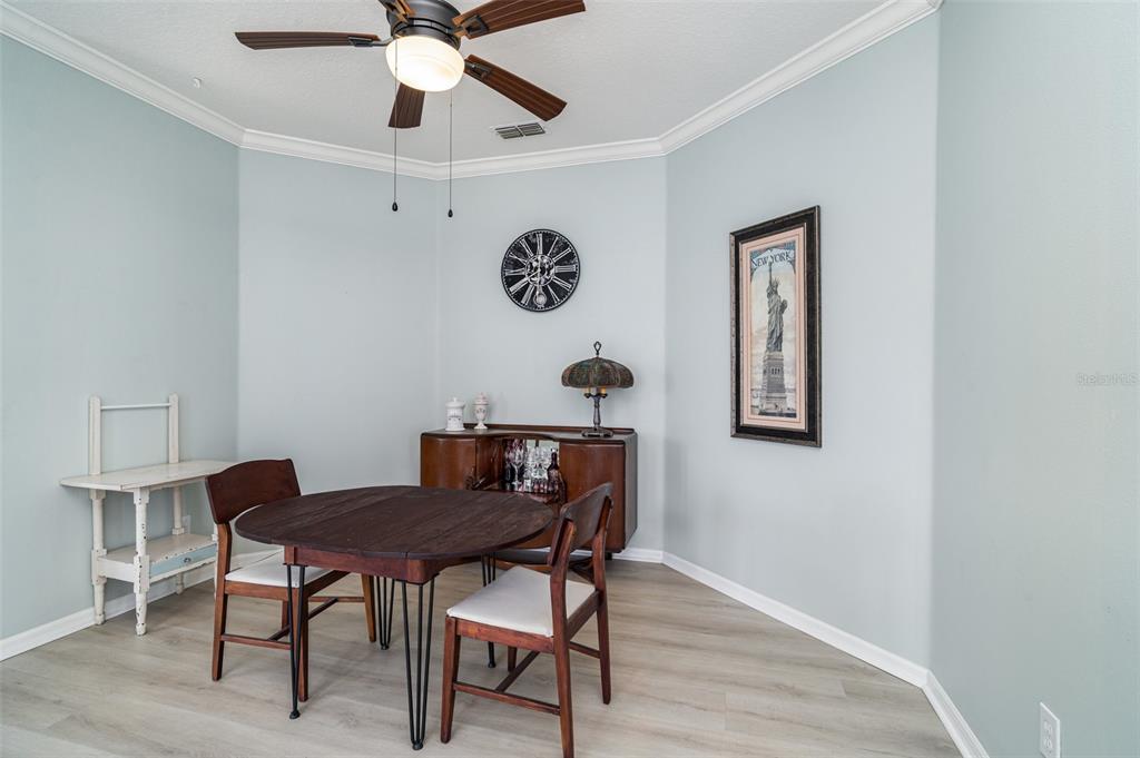 302 Latitude Place Apollo Beach, FL 33572 - Photo 5 of 50 a view of a workspace room with furniture and wooden floor