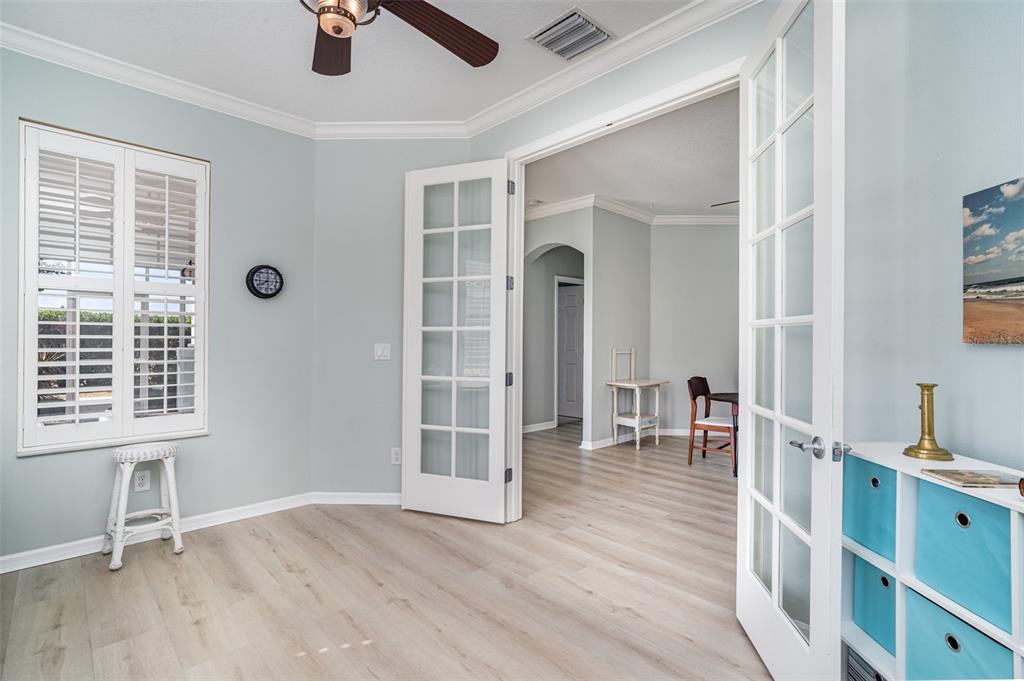302 Latitude Place Apollo Beach, FL 33572 - Photo 6 of 50 an empty room with wooden floor and windows