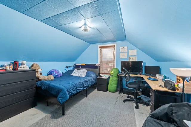 a bedroom with a bed and a desk