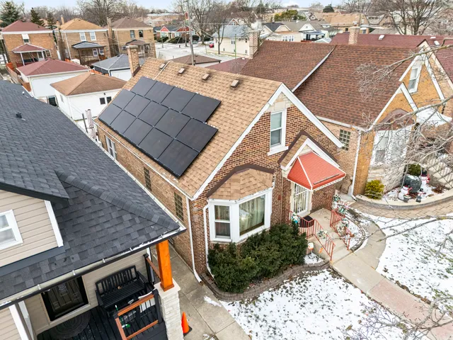 an aerial view of a house with a yard
