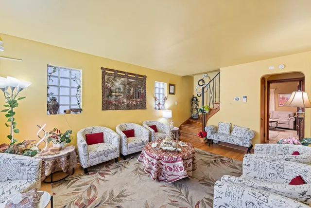 a bedroom with furniture and a wooden floor