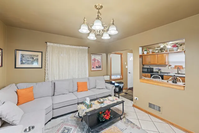 a living room with furniture a couch and chandelier