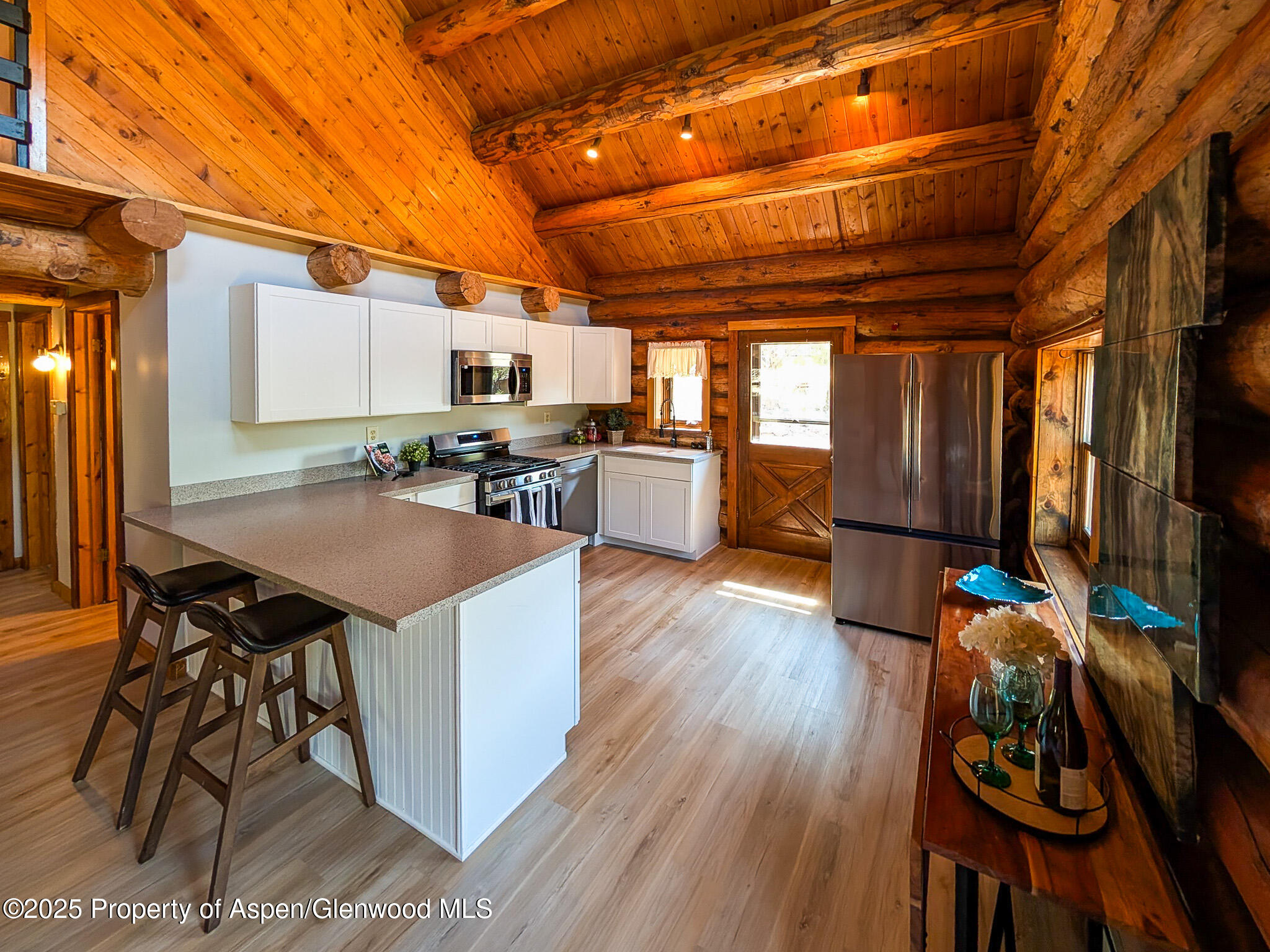 96 Apache Drive New Castle, CO 81647 - Photo 9 of 34 a dining room with wooden floors and wooden cabinets