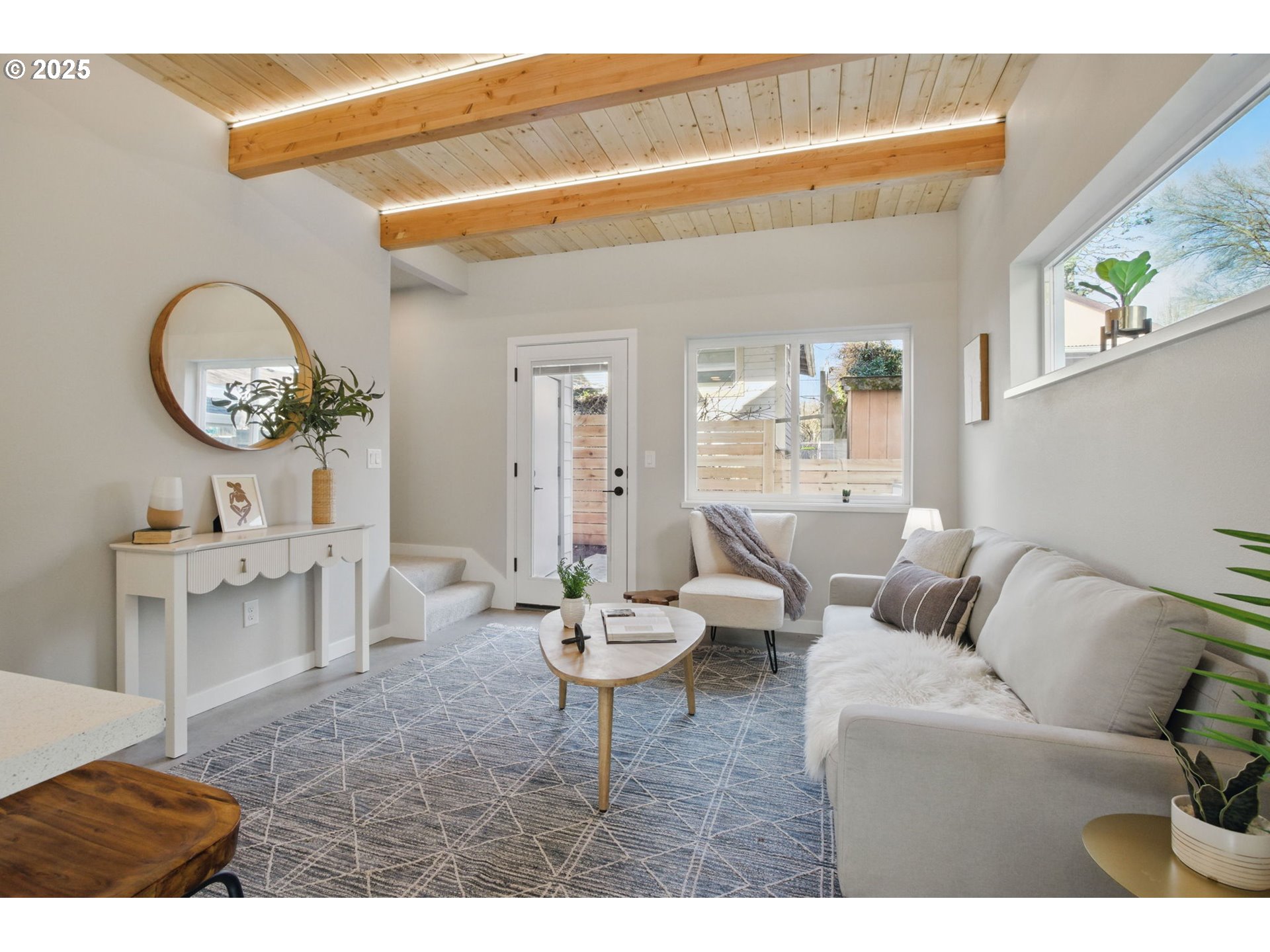 1123 Southeast Rhone Street, Unit B Portland, OR 97202 - Photo 13 of 30 a living room with furniture a window and a clock