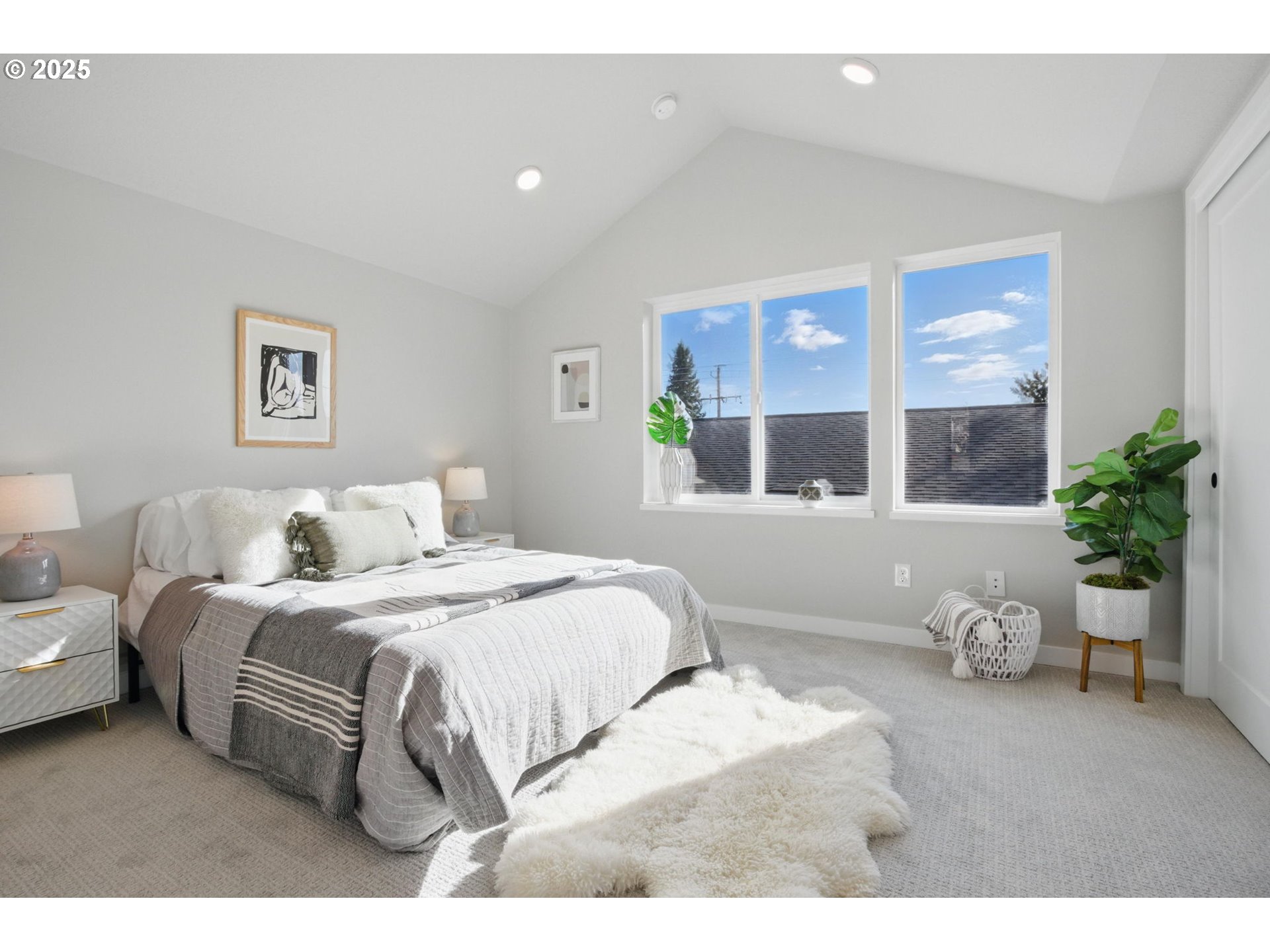 1123 Southeast Rhone Street, Unit B Portland, OR 97202 - Photo 24 of 30 a bedroom with a large bed and windows