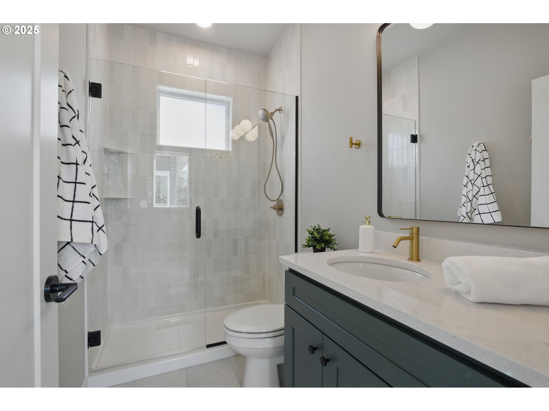 1123 Southeast Rhone Street, Unit B Portland, OR 97202 - Photo 26 of 30 a bathroom with a granite countertop sink a toilet and shower