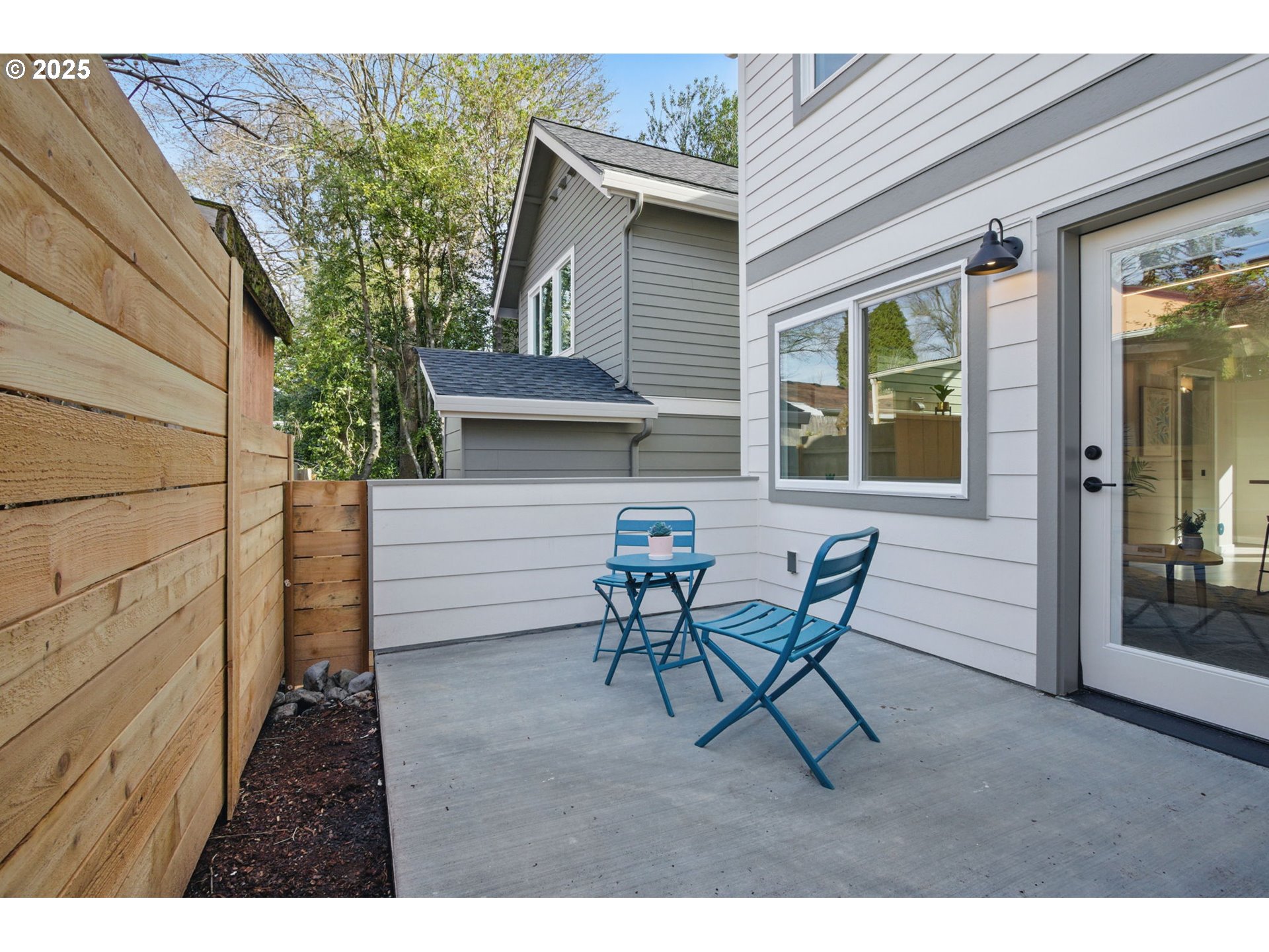 1123 Southeast Rhone Street, Unit B Portland, OR 97202 - Photo 29 of 30 a view of a patio with table and chairs and wooden floor